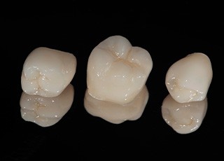 Three dental crowns sitting in a row