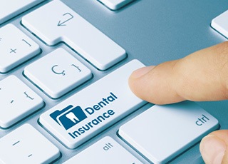 Pressing dental insurance key on keyboard