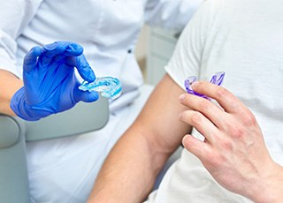 Dentist presents patient with mouthguards